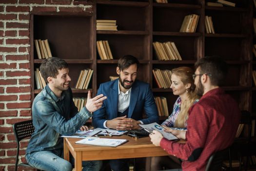 successful business team discussing a financial report on the company's profits in the workplace in the office