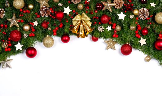 Christmas Border frame of fir tree branches on white background with copy space isolated, red and golden decor, berries, stars