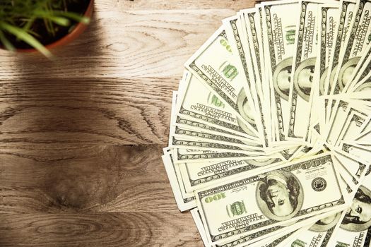 Photo banknotes US dollars on wooden background, on the left there is a place for advertising text