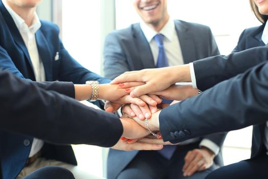 Group of businessman team touching hands together. Selective focus.