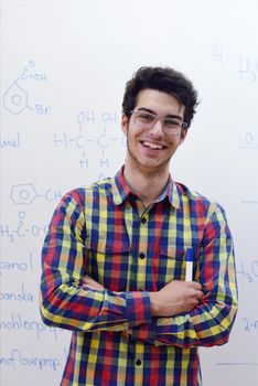 happy young teenage boy portrait in school on chemistry classes and library