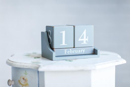 stylish Desk calendar with the words 'February 14' on the bedside table. the photo has a empty space for your text