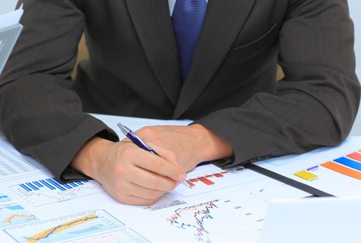 Businessman analyzing investment charts at his workplace