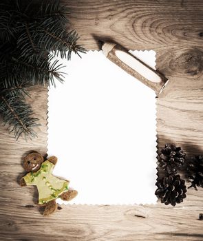 blank sheet of paper on the wooden floor with a pencil and Christmas decorations