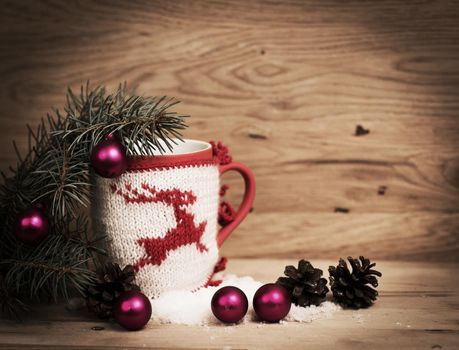Christmas mug with Christmas decorations on wooden background