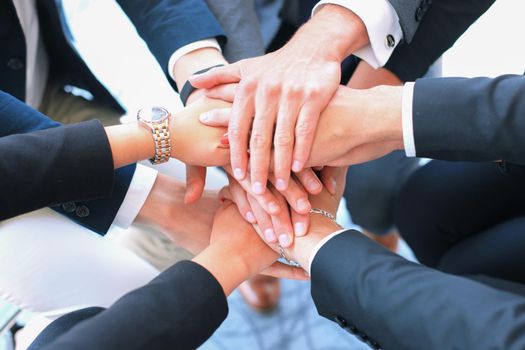 Group of businessman team touching hands together. Selective focus.