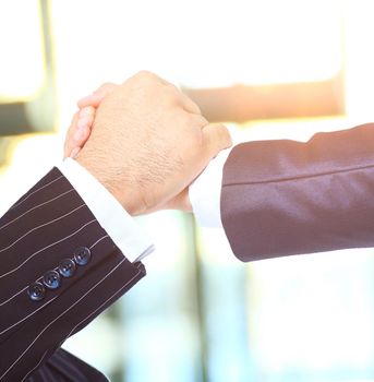 Make a deal. Handshake on an office background on a sunny day