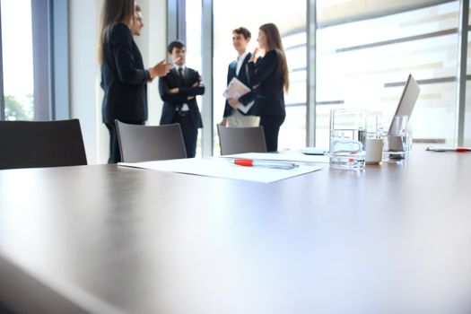 Team young professionals having casual discussion in office. Executives having friendly discussion during break.