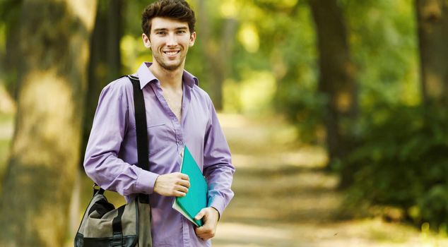 successful student with books in the Park on a Sunny day.