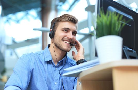 Smiling friendly handsome young male call centre operator