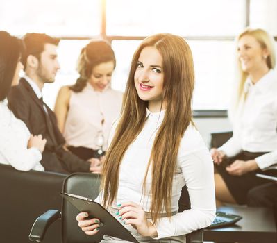 business girl on the background of working business team in office