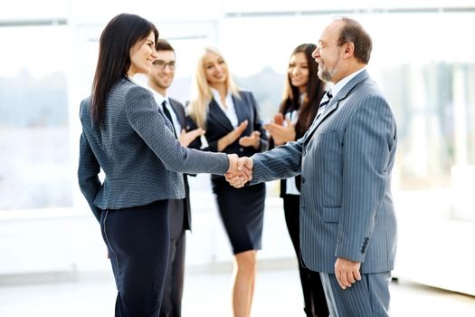 business meeting business partners in office with a handshake