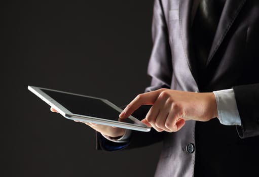 Young businessman working with modern devices, digital tablet computer and mobile phone.