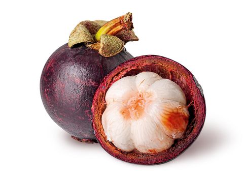 Whole and open mangosteen isolated on white background