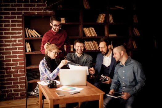 team of copywriters discussing a new advertising project in modern office