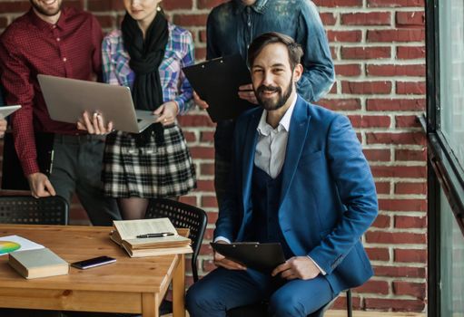 head of the new project against the background of business team in a modern office