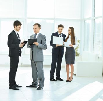 successful business team debating and discussing work in front of a business meeting in the lobby