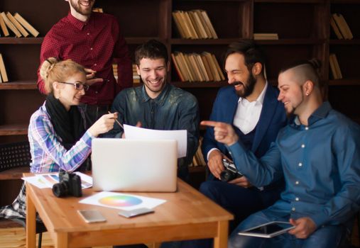 team of copywriters discussing a new advertising project in modern office