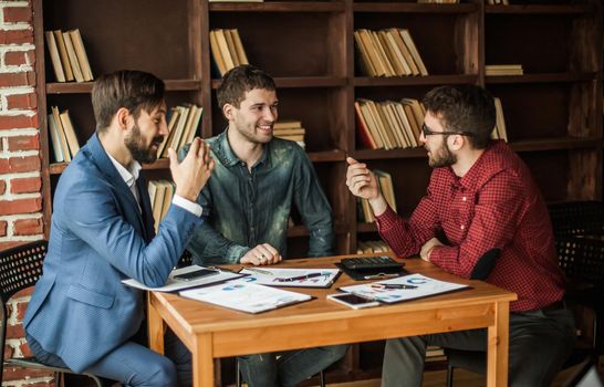 successful business team is working with the financial schedules in the workplace in modern office