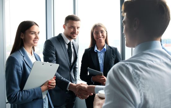 Business handshake. Business people shaking hands, finishing up a meeting