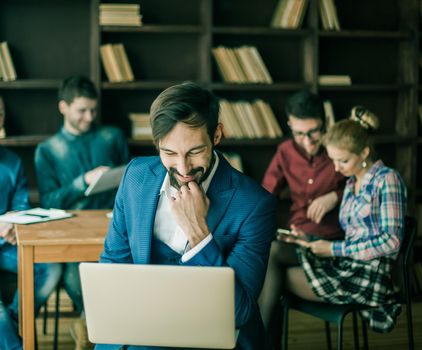 sales Manager with a laptop and a business team discussing the current problems of the company