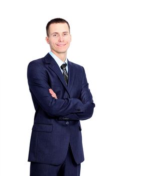young business man standing with his hands crossed on a white background, smiling and looking at the camera
