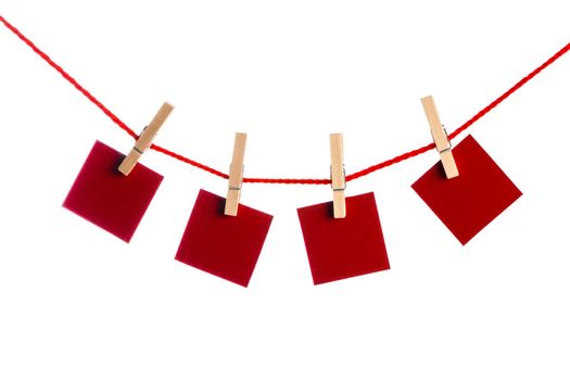 Red Memo papers with clothespins on a leash. Isolated on white background. Love copy space for letters