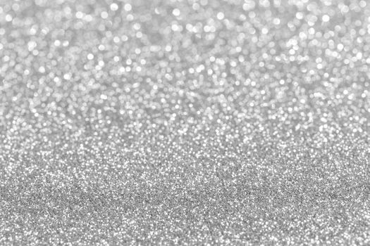 Shiny silver defocused glitter holiday background with copy space