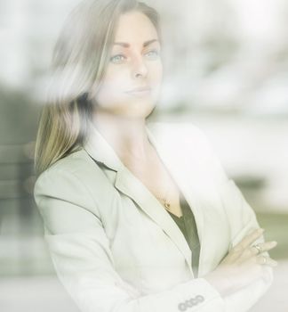 Young beautiful successful business woman standing near wind