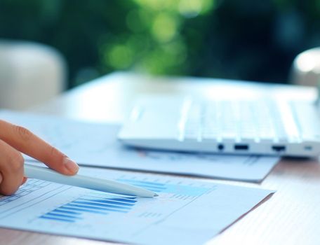 Close-up of Businesswoman makes a note at business document