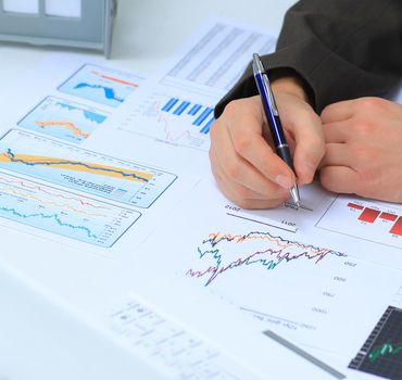 Businessman analyzing investment charts at his workplace