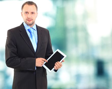 Portrait of a young office worker using a tablet computer in his office