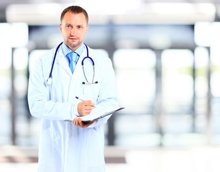 portrait of doctor in white coat and stethoscope with arms crossed