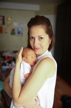 mother with newborn baby in the nursery