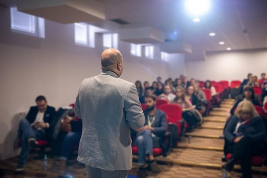 young businessman at business conference room with public giving presentations. Audience at the conference hall. Entrepreneurship club