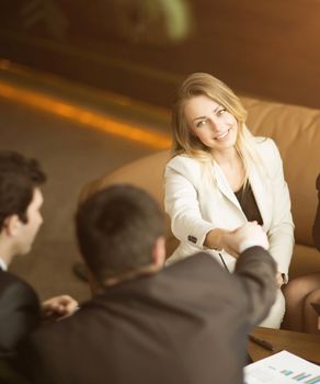 A diverse attractive man and woman business team handshake at office building