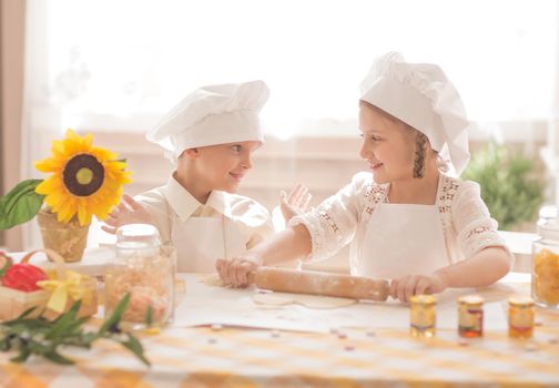 happy little children in the form of a chef to cook a delicious breakfast the kitchen