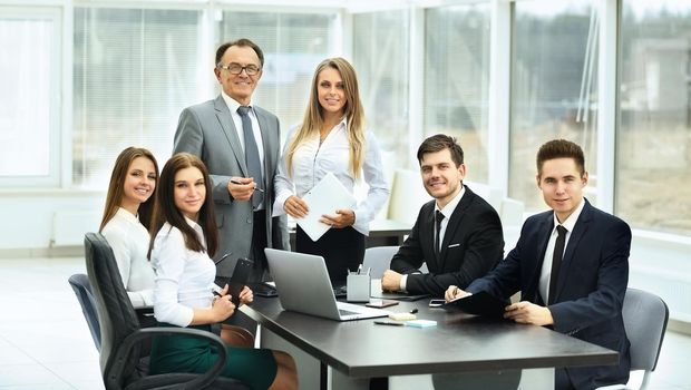 meetings with business partners in modern office, looking at the camera