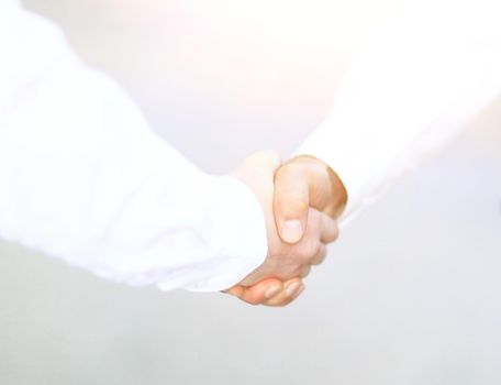 Two business men shaking hands in the office