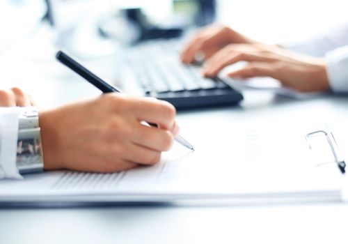 Business lady taking business notes at office