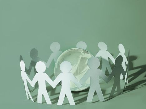 Team of paper doll people holding hands