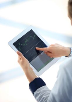 Close-up image of an office worker using a touchpad to analyze statistical data