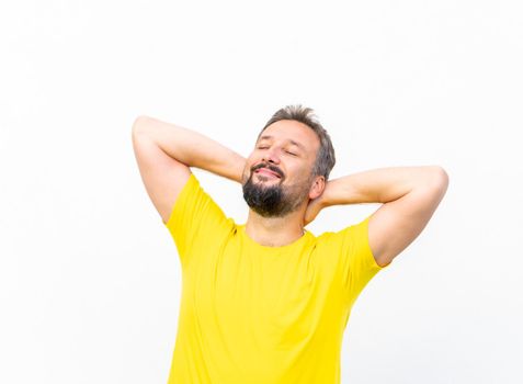 One positive man with yellow shirt portrait against wall