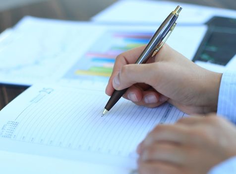 Business lady taking business notes at office