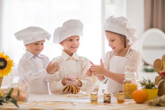 happy little children in the form of a chef to cook a delicious breakfast the kitchen