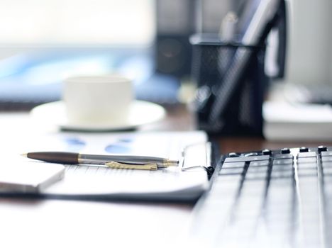 Office supplies and coffee cup on table