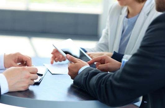 businessman hands touching digital tablet empty screen copy space, handshake during meeting.