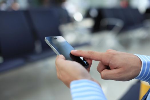 Close up of a man using mobile smart phone