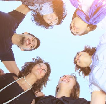 group of young students in a circle on the sky looking at each other