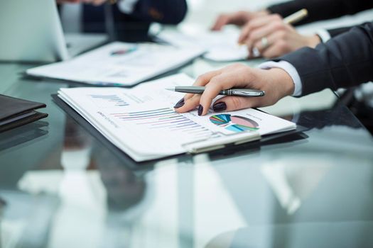closeup of business team discussing financial charts on a workplace in a modern office
